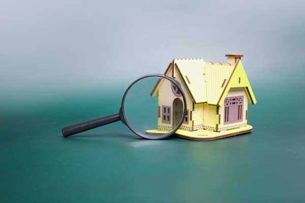 modal house with magnifying glass